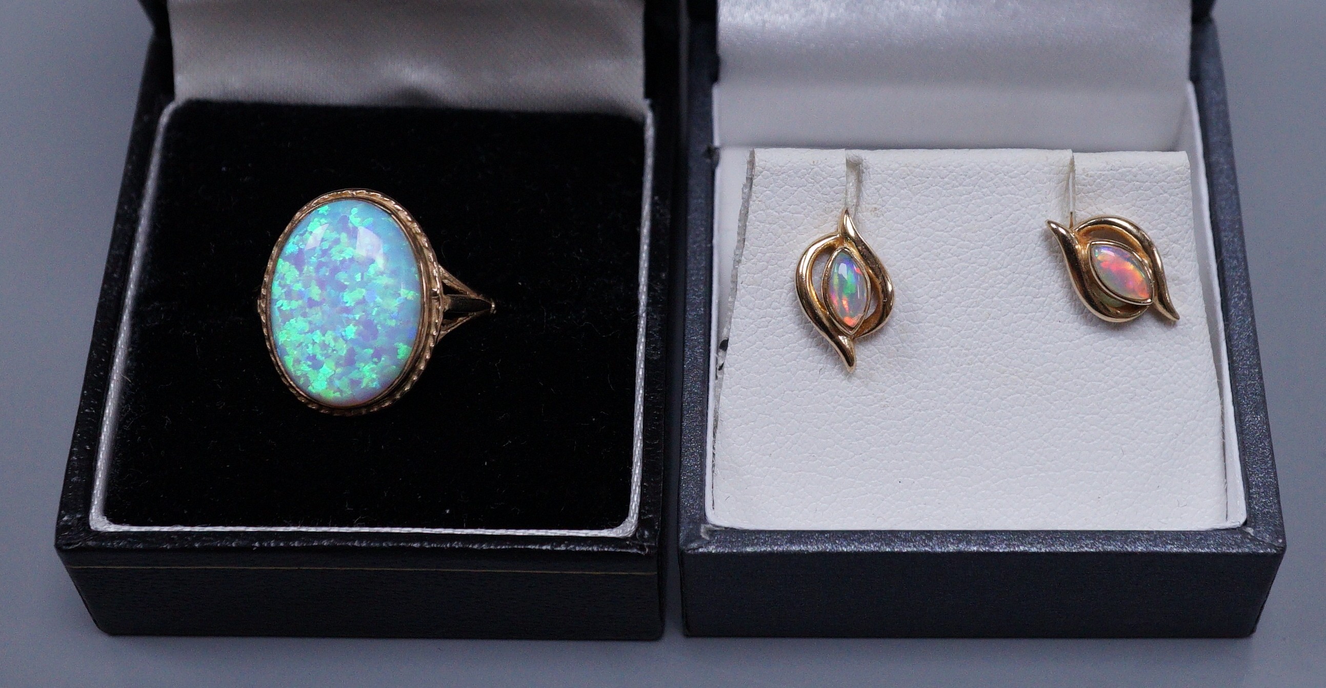 A 9ct gold white opal doublet ring, size O and a pair of white opal mounted ear studs